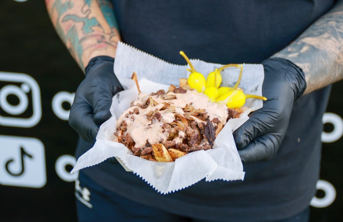 Fat Fries loaded with grass-fed beef, grilled onions, sauce, and pepperoncini